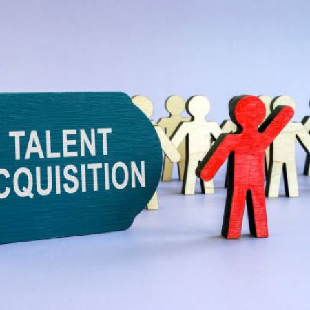 Talent acquisition written on dark plate and wooden figurines.